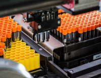 Barcoded cryotubes loaded into a robotic handling system for processing.